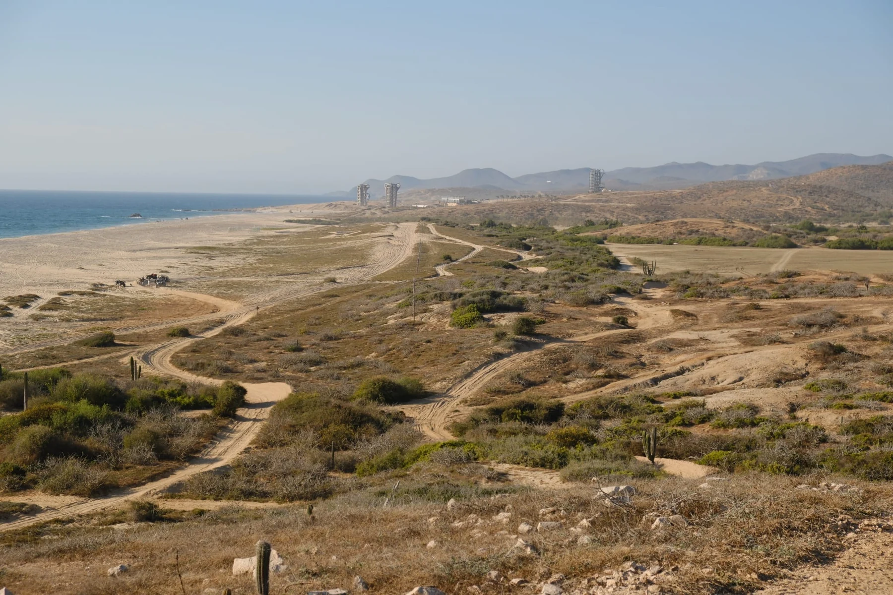 Wide view of desert paths, coast and mountains